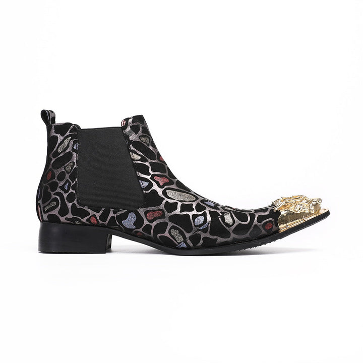 Pair of men's black Chelsea boots with a metallic leopard print pattern and ornate gold metal toe caps, shown on a white