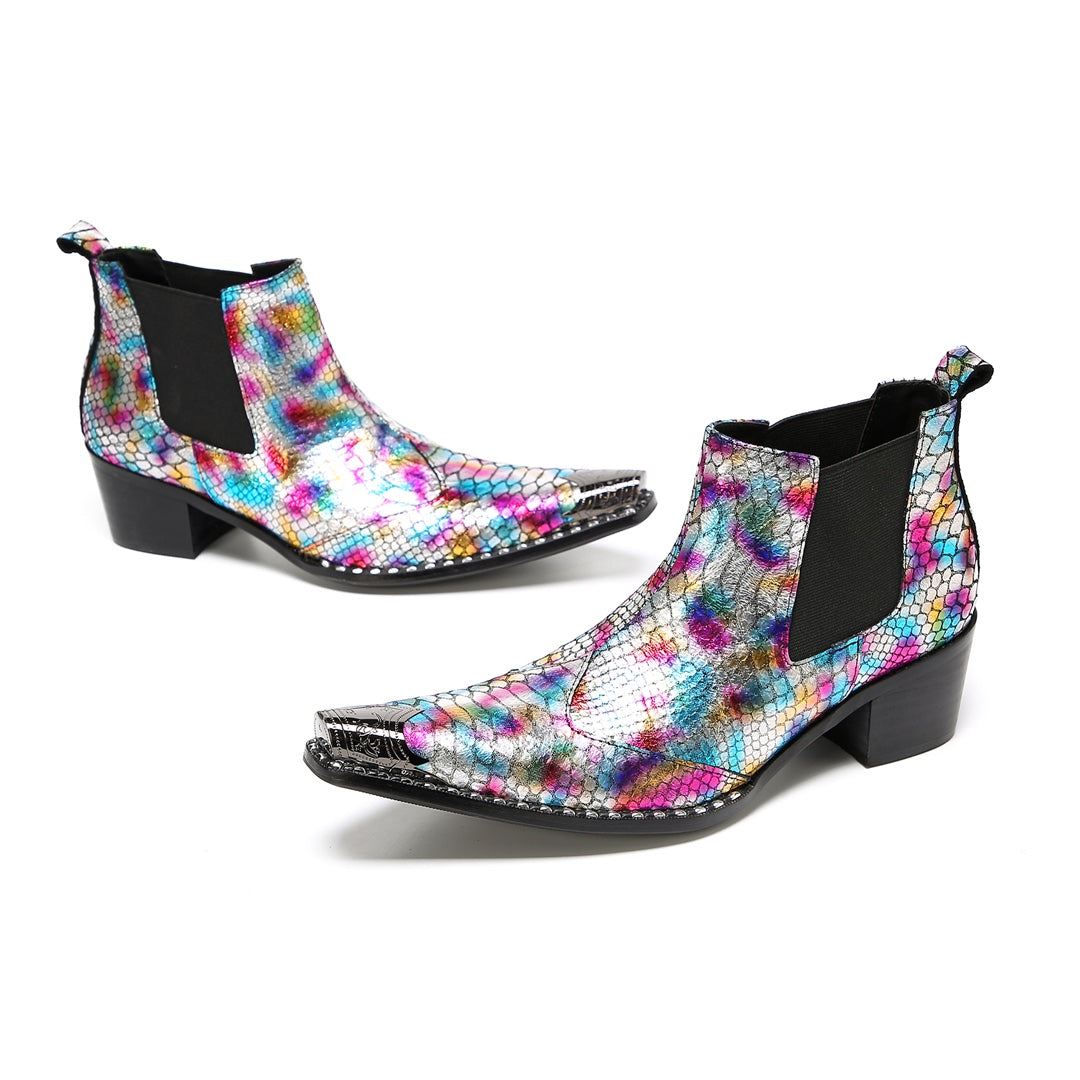 A pair of multi-color iridescent snakeskin Chelsea ankle boots with pointed metal toe caps and black block heels.