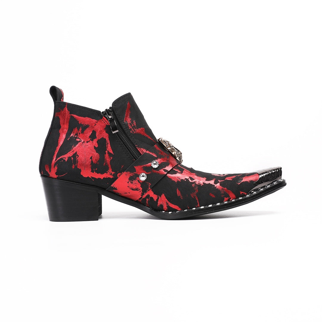 A pair of men's black and red patterned ankle boots with a silver metal pointed toe and a wolf head embellishment on the