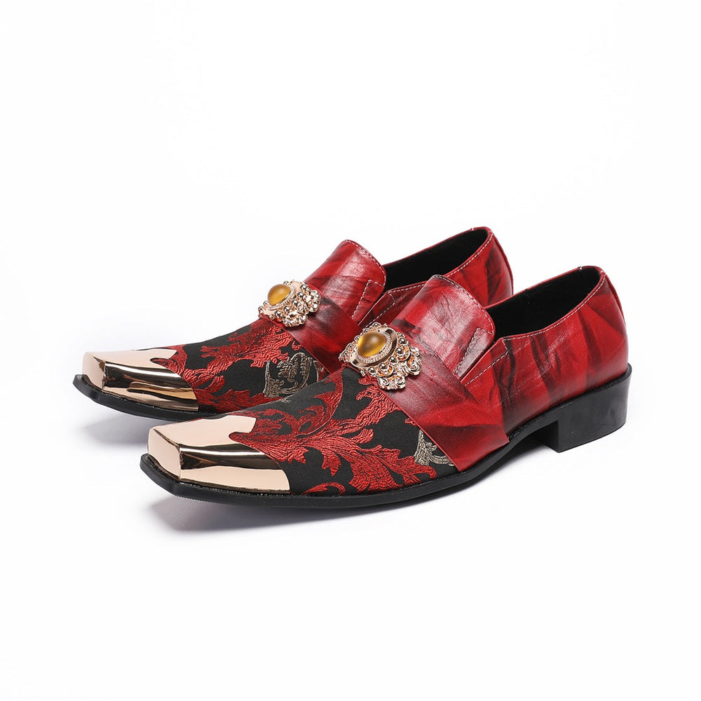 Pair of men's red and black floral slip-on loafers with gold metal square toe and decorative buckle.