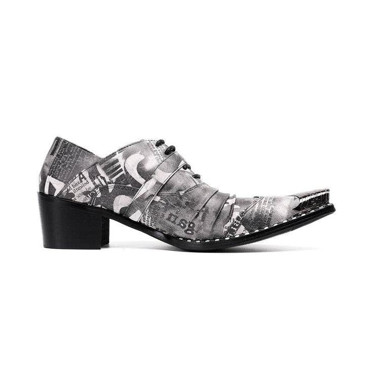 Pair of men's high heel derby shoes with a black and white newspaper print, pointed metal toe caps, and buckle details, shown