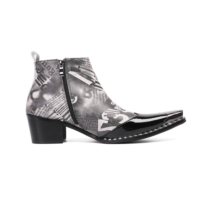 Pair of men's black and white newspaper print ankle boots with a shiny black pointed toe and silver metal tip, side zipper