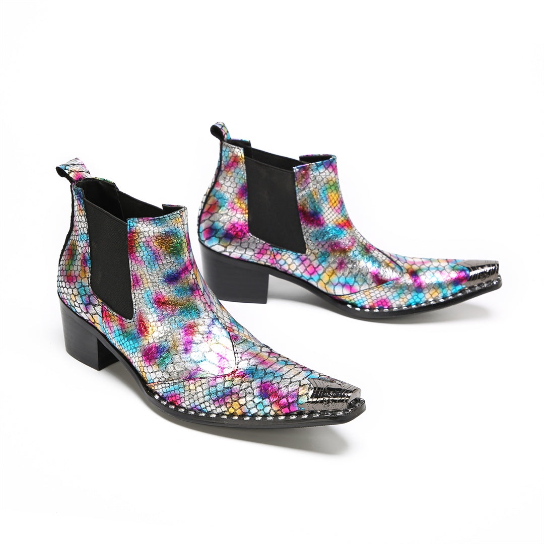 A pair of multi-color iridescent snakeskin Chelsea ankle boots with pointed metal toe caps and black block heels.