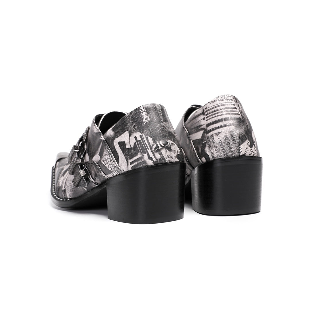 A pair of Dolashoes men's pointed toe lace-up shoes with a gray newspaper print, metal toe cap, and block heel.