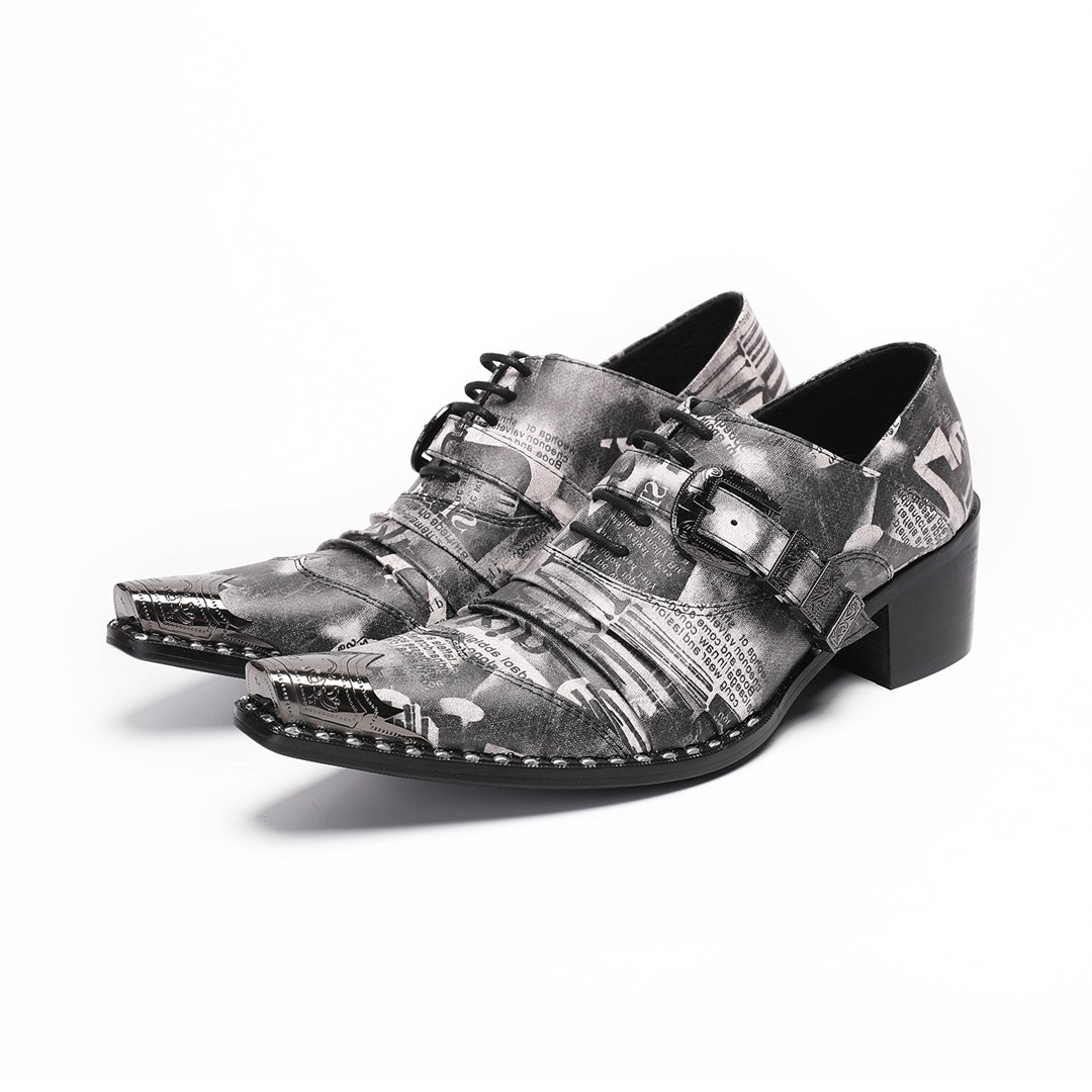 Pair of men's high heel derby shoes with a black and white newspaper print, pointed metal toe caps, and buckle details, shown