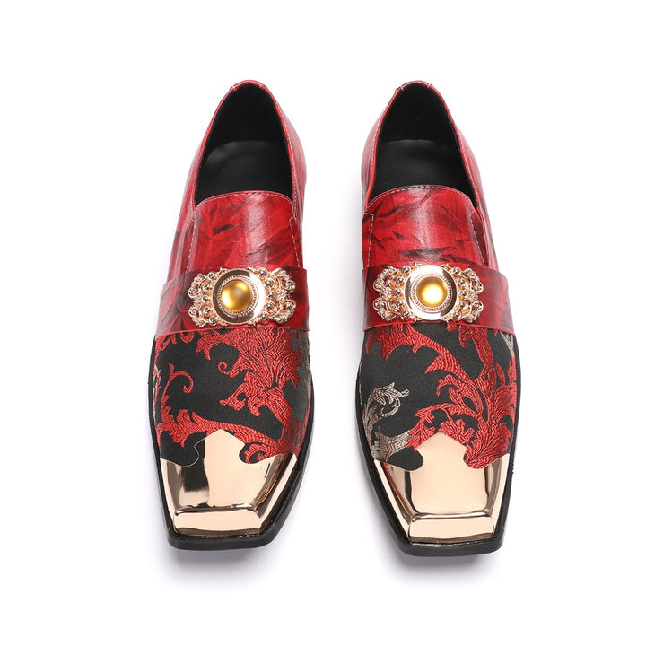 Pair of men's red and black floral slip-on loafers with gold metal square toe and decorative buckle.