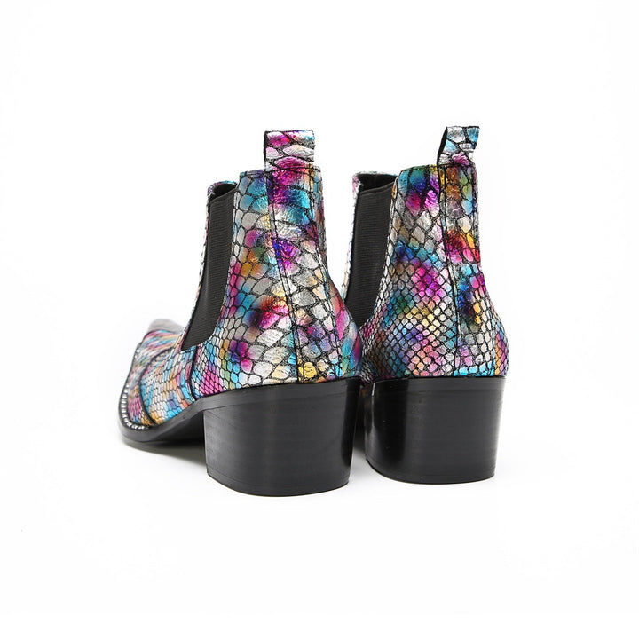 A pair of multi-color iridescent snakeskin Chelsea ankle boots with pointed metal toe caps and black block heels.