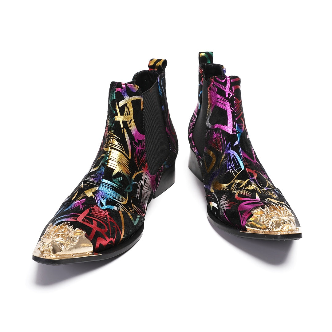 Pair of men's black Chelsea boots with a vibrant multi-color graffiti pattern and a gold metal pointed toe cap, shown from