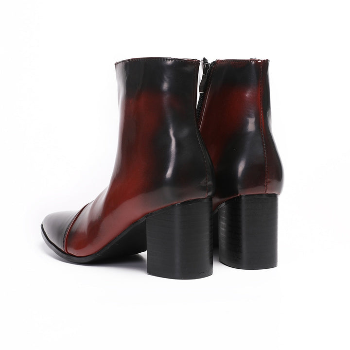 Pair of men's burnished red and black pointed toe ankle boots with a side zipper and sturdy block heel.