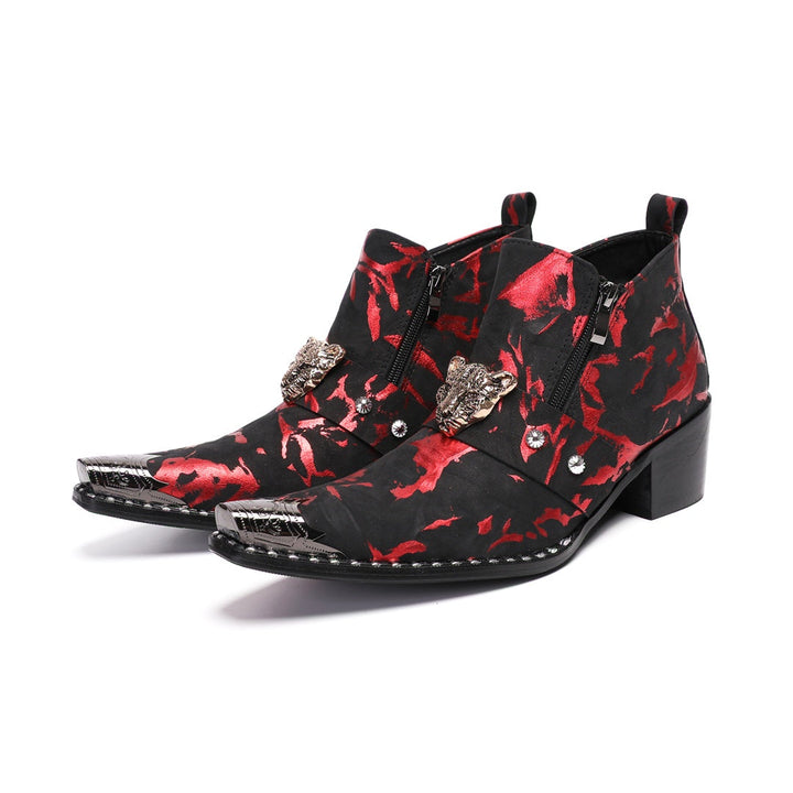 A pair of men's black and red patterned ankle boots with a silver metal pointed toe and a wolf head embellishment on the