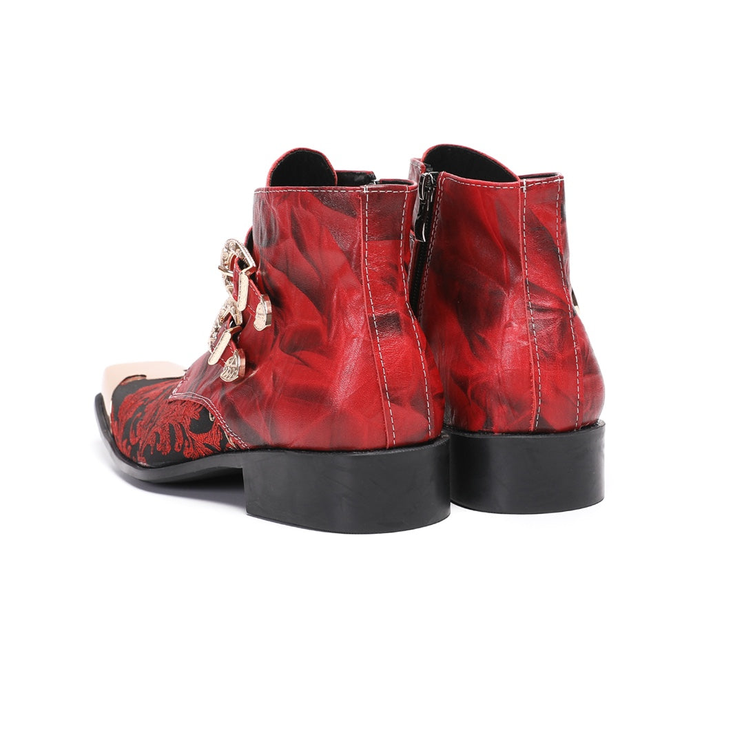 Pair of men's red and black embroidered ankle boots with gold metal square toe caps and double buckle straps.
