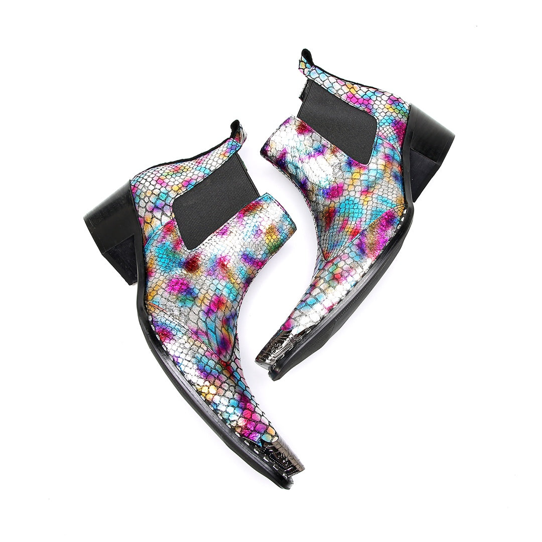 A pair of multi-color iridescent snakeskin Chelsea ankle boots with pointed metal toe caps and black block heels.