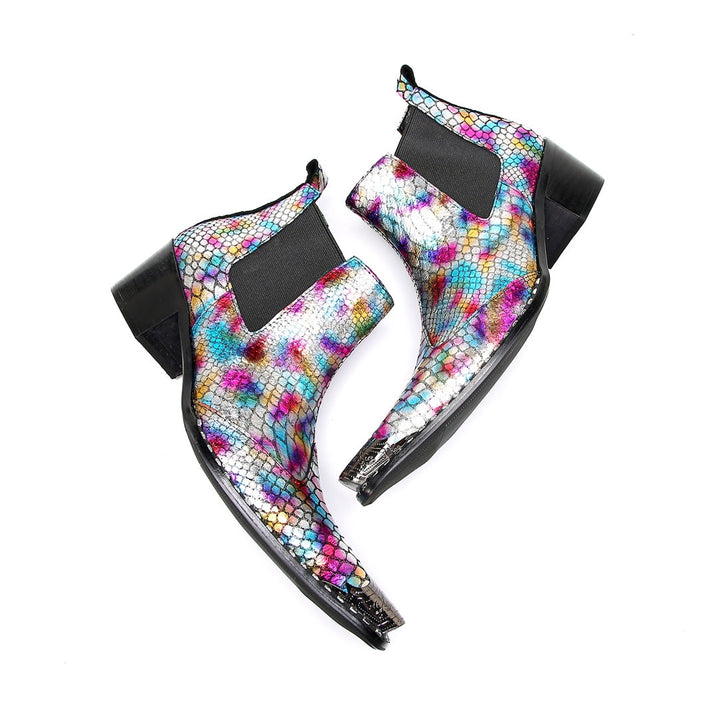 A pair of multi-color iridescent snakeskin Chelsea ankle boots with pointed metal toe caps and black block heels.