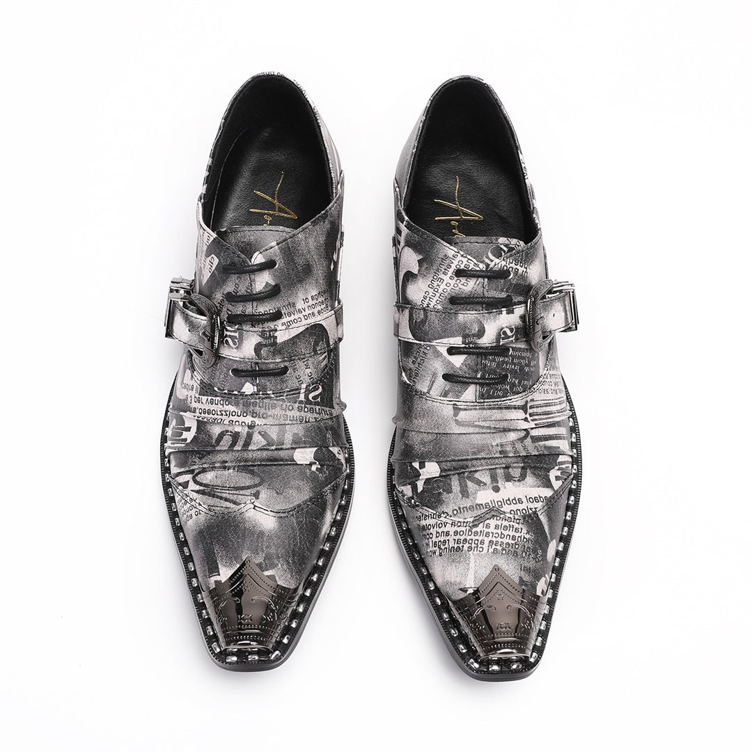 Pair of men's high heel derby shoes with a black and white newspaper print, pointed metal toe caps, and buckle details, shown