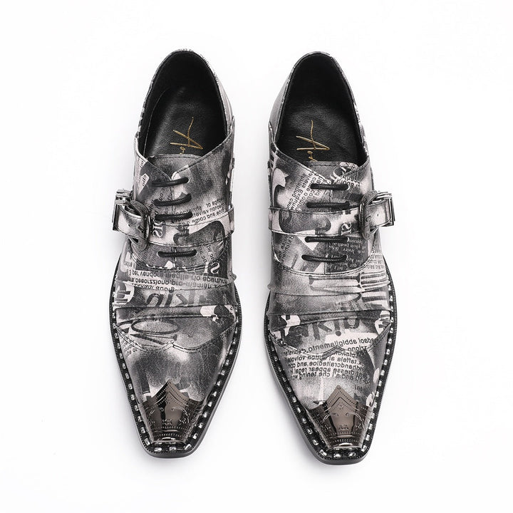 Pair of men's high heel derby shoes with a black and white newspaper print, pointed metal toe caps, and buckle details, shown