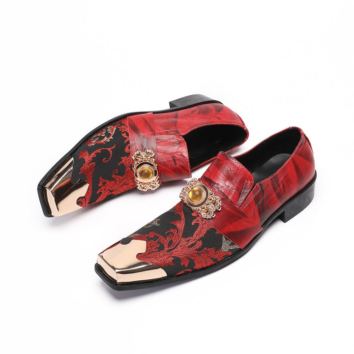 Pair of men's red and black floral slip-on loafers with gold metal square toe and decorative buckle.