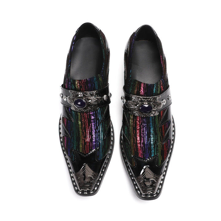 A single black patent leather men's dress shoe with a pointed metal toe, rainbow-striped vamp, and a decorative silver buckle