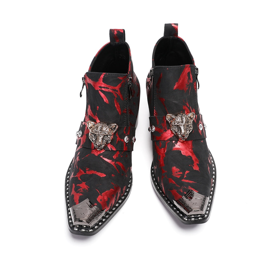 A pair of men's black and red patterned ankle boots with a silver metal pointed toe and a wolf head embellishment on the