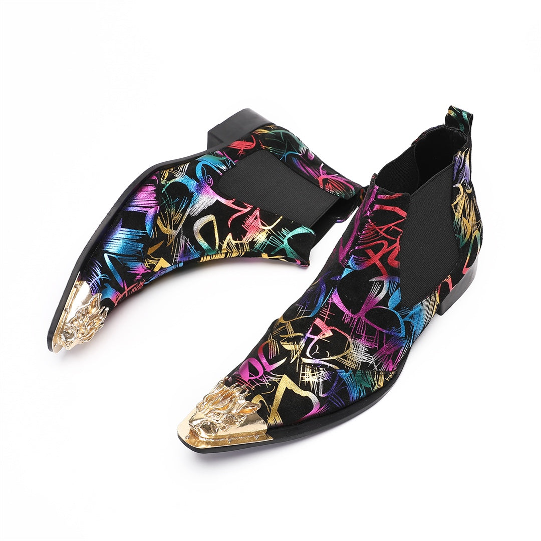 Pair of men's black Chelsea boots with a vibrant multi-color graffiti pattern and a gold metal pointed toe cap, shown from