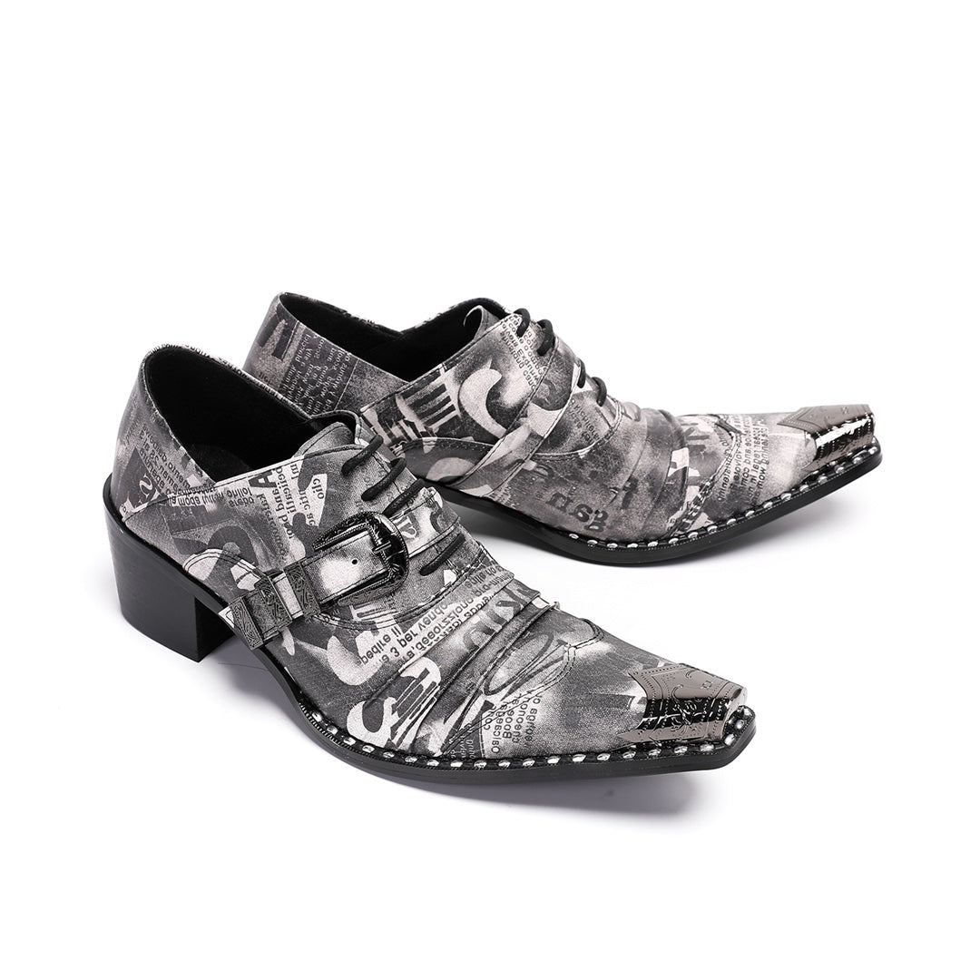 Pair of men's high heel derby shoes with a black and white newspaper print, pointed metal toe caps, and buckle details, shown