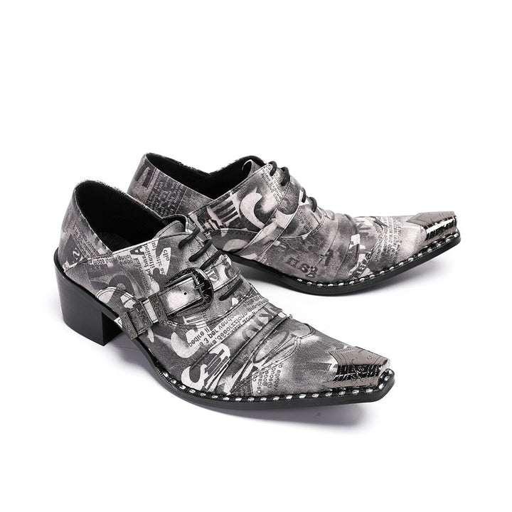 Pair of men's high heel derby shoes with a black and white newspaper print, pointed metal toe caps, and buckle details, shown