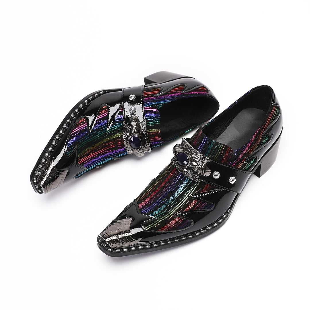 A single black patent leather men's dress shoe with a pointed metal toe, rainbow-striped vamp, and a decorative silver buckle