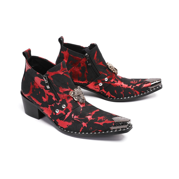 A pair of men's black and red patterned ankle boots with a silver metal pointed toe and a wolf head embellishment on the