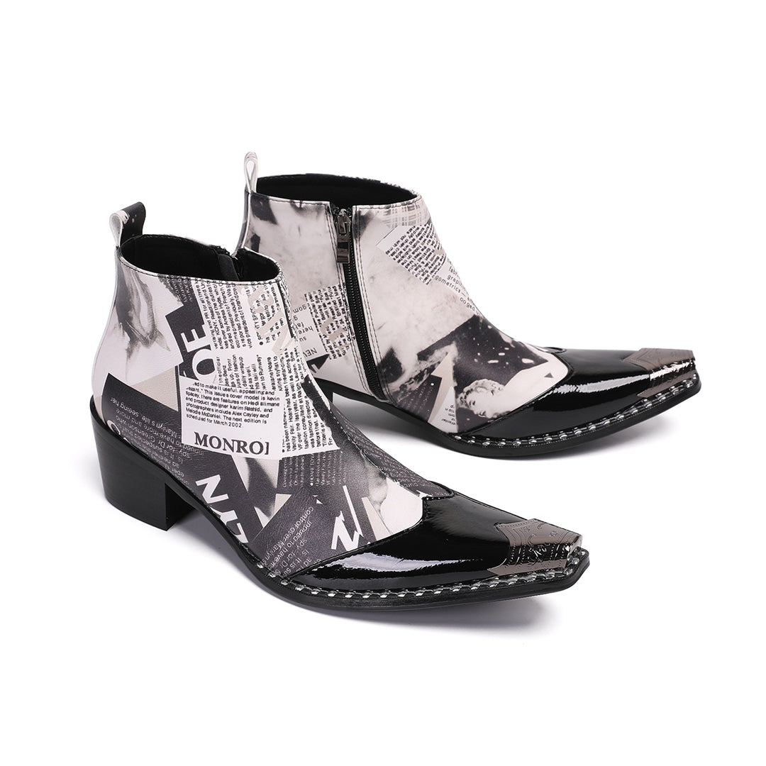 Pair of men's black and white newspaper print ankle boots with pointed patent leather toe and metal tip, side zipper, and