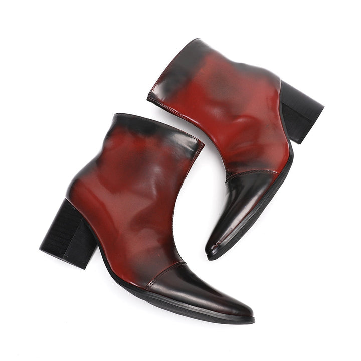 Pair of men's burnished red and black pointed toe ankle boots with a side zipper and sturdy block heel.