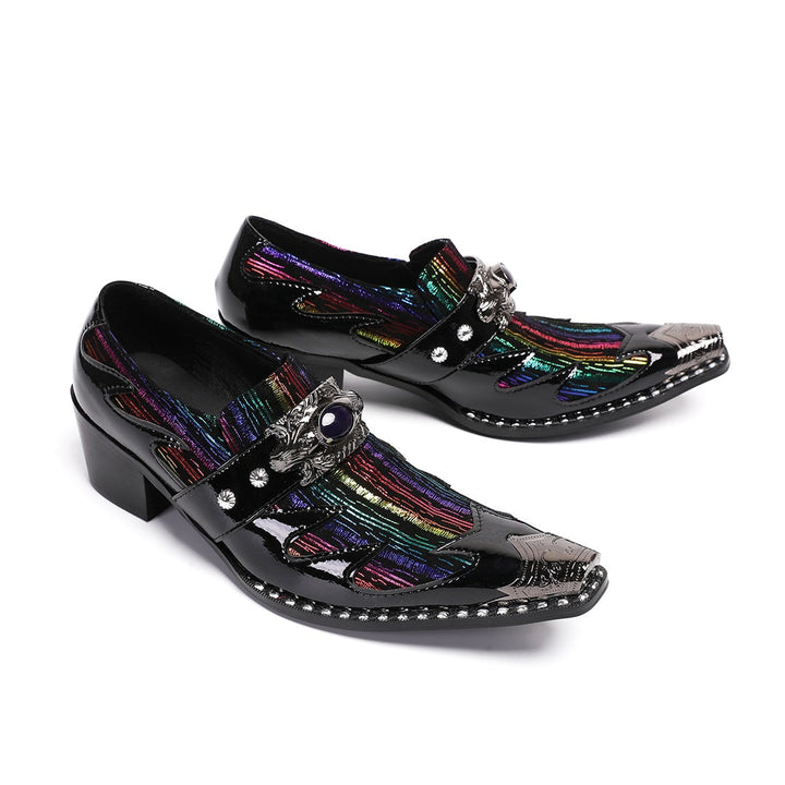 A single black patent leather men's dress shoe with a pointed metal toe, rainbow-striped vamp, and a decorative silver buckle