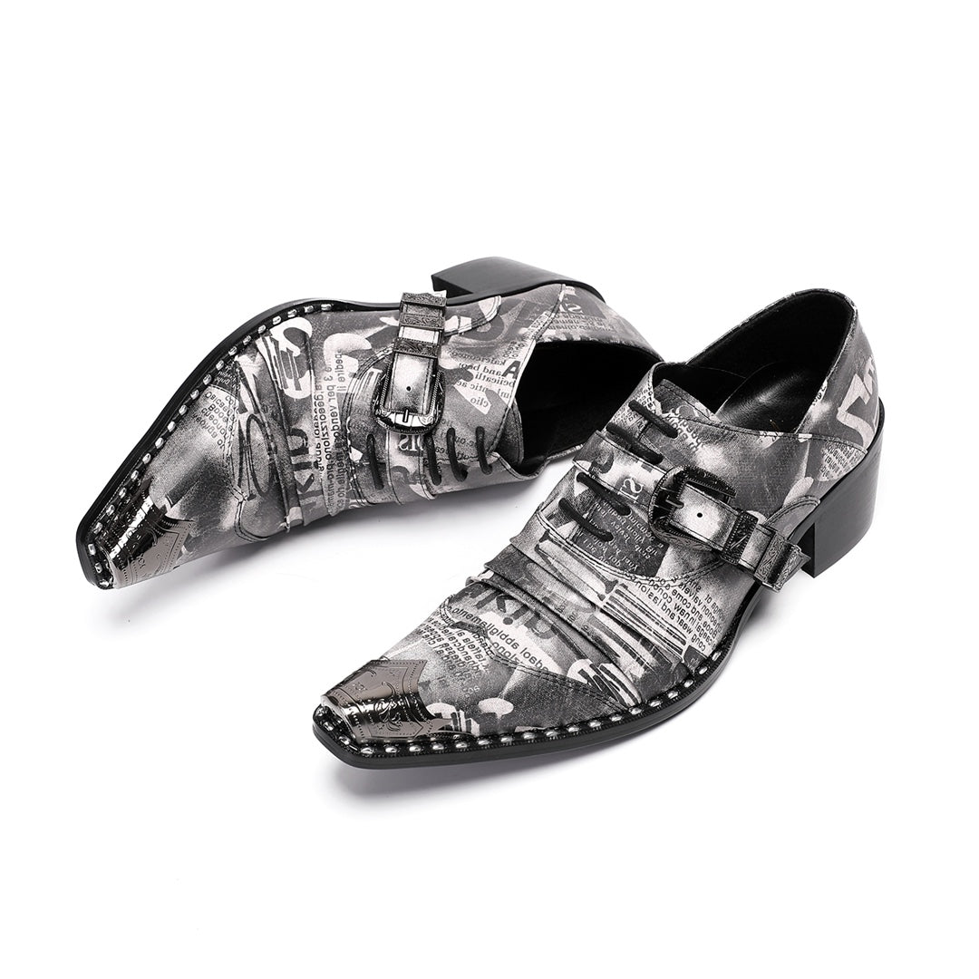 Pair of men's high heel derby shoes with a black and white newspaper print, pointed metal toe caps, and buckle details, shown