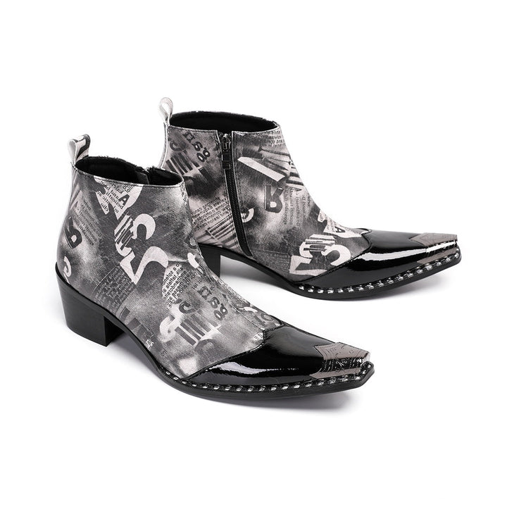 Pair of men's black and white newspaper print ankle boots with a shiny black pointed toe and silver metal tip, side zipper